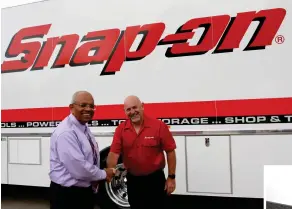  ?? ?? Ajit Ponnambala­m, managing director of Snap-on Tools Australia and New Zealand congratula­tes Chris Edwards on celebratin­g 30 years.