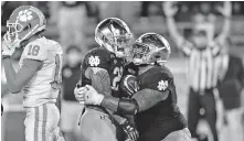  ?? [MATT CASHORE/USA TODAY SPORTS] ?? Notre Dame running back Kyren Williams (23) celebrates with offensive lineman Aaron Banks (69) after scoring the game-winning touchdown in the second overtime against Clemson on Saturday.