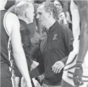  ?? CHRIS LACHALL/USA TODAY NETWORK ATLANTIC GROUP ?? Princeton men's basketball coach Mitch Henderson, center, right, shakes hands with Rutgers men's basketball coach Steve Pikiell after Princeton defeated Rutgers, 68-61, in Monday's game at the Cure Insurance Arena in Trenton.