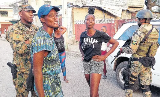  ?? PHOTO BY ROXROY MCLEAN ?? These women were detained after alleging abuse by soldiers in Denham Town, West Kingston. They said a pregnant woman, their relative, was allegedly assaulted by JDF soldiers.