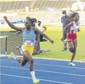  ??  ?? Oneka Wilson of Hydel High prepares to celebrate winning the Class One 100m hurdles final.