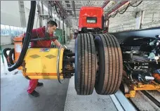  ?? LU QIJIAN / FOR CHINA DAILY ?? A worker assembles a truck on Friday at a workshop of Anhui Jianghuai Automobile Group Co in Fuyang, Anhui province.