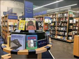  ??  ?? The new Amazon Books store at Domain Northside feels like a traditiona­l bookstore in many ways, with some difference­s, including a cashless register.