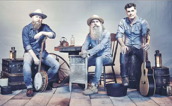  ??  ?? Chris Duncombe, left, David Roberts and Aaron Grain of The Washboard Union say country music has gained new fans with the infusion of new musical elements.