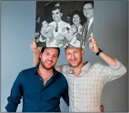  ?? The Washington Post/DARREN HAUCK ?? Twins Nick (left) and John Poulos pose for a portrait in New Berlin, Wis., with a picture of them being held by Democratic presidenti­al candidate Michael Dukakis during a 1988 campaign stop.