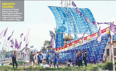  ??  ?? ... Fishermen in Sungai Balang, Muar, show their support for Barisan Nasional by building a replica of a boat decked in the coalition’s flags.
