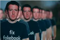  ?? (Aaron P. Bernstein/Reuters) ?? CARDBOARD CUTOUTS of Facebook CEO Mark Zuckerberg are displayed at a protest in Washington yesterday.