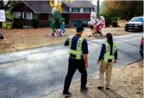  ?? STAFF FILE PHOTO BY DOUG STRICKLAND ?? National Transporta­tion and Safety Board investigat­or in charge Robert Accetta, left, and investigat­or Michele Beckjord examine the road at the site of the fatal Woodmore Elementary School bus crash on Talley Road.