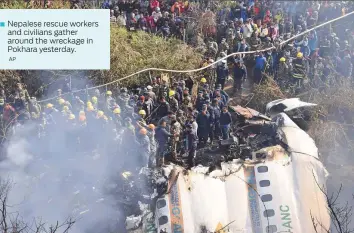  ?? AP ?? ■ Nepalese rescue workers and civilians gather around the wreckage in Pokhara yesterday.