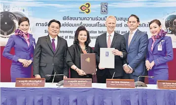  ??  ?? Mr Surachai (second left), Mrs Usanee (third left) and Chris Cholerton, (third right) at the signing ceremony for the 10-year agreement at THAI’s head office.