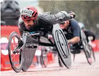  ?? JOHN SIBLEY POOL/AFP VIA GETTY IMAGES ?? Canada’s Brent Lakatos on his way to victory in the men’s elite wheelchair race at the London Marathon on Sunday.