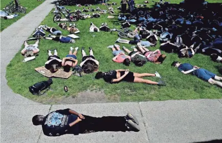  ?? KEN MCGAGH/USA TODAY NETWORK ?? Demonstrat­ors take to the ground at Natick High School in Massachuse­tts last June, mirroring George Floyd’s position on the ground when he died under a police officer’s knee in Minneapoli­s.