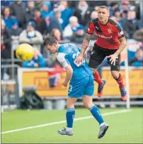  ??  ?? RED PERIL: Kenny Miller, main picture, is mobbed by his team-mates after scoring from his speculativ­e shot. James Tavernier, left, challenges Jordan Marshall