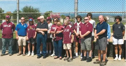  ?? KEITH GROLLER/MORNING CALL ?? State Rep. Jeanne McNeill (center, holding child) poses with Coplay Mayor Steve Burker (right of McNeill), Coplay Sports President Wes Christman
(far left), Coplay baseball players and other borough officials at a ceremony at Balliet Stadium announcing a grant that will restore lights to the historic ballpark.