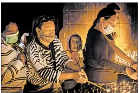  ?? CHRIS MCGRATH/GETTY ?? Women light oil lamps in Kathmandu, Nepal, on Monday as part of celebratio­ns to mark Buddha’s birthday. Thousands remain displaced by last month’s earthquake.