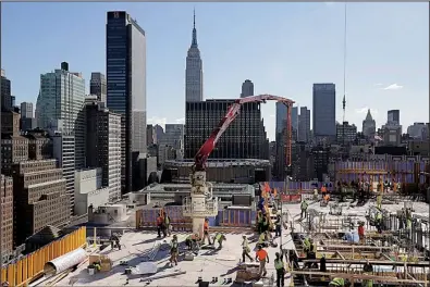  ?? AP/MARK LENNIHAN ?? Constructi­on continues on the building known as 3 Manhattan West in New York in October. U.S. constructi­on spending rose 0.6 percent in September, the Commerce Department said Monday.