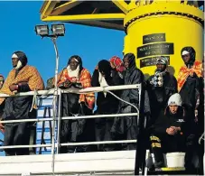  ?? Reuters ?? Hoping for a better life: Migrants wait for the MV Aquarius, a search-andrescue ship run in partnershi­p between SOS Mediterran­ee and Medecins Sans Frontieres, to enter Pozzallo on the island of Sicily, Italy, in November 2017. /