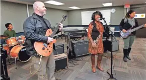  ?? ANGELA PETERSON/MILWAUKEE JOURNAL SENTINEL ?? Randy Yocum, left, plays the guitar, with son Jeremy, 20, on the drums, while his wife, Victoria, center, does lead vocals and their daughter Tori, 21, plays the bass guitar at MATC this month. Randy owned a trucking business before returning to school...