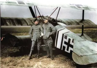  ??  ?? ■ Two close comrades of Jasta 11, Werner Steinhäuse­r (L) and Richard Wenzl are seen with Wenzl’s Dreidecker at Cappy airfield in late April 1918. The Fokker bore Wenzl’s favoured personal insignia of a black and white fuselage band in the proportion­s of the Iron Cross ribbon, but with colours reversed. It would also have the Staffel markings of red struts, wheel cover and engine cowling. Steinhäuse­r was posted to Staffel 11 in December 1917, his score of ten victories including two balloons. He was killed in action on 26 June 1918.