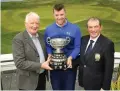  ??  ?? Peter O’Keeffe is presented with the trophy by Frank Hayes (Kerry Group PLC) and Kevin McCarthy (Captain Tralee Golf Club)