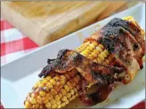  ?? Tribune News Service ?? Bacon-wrapped Corn with Chipotle Glaze.