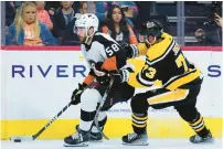  ?? ?? Philadelph­ia Flyers’ Tanner Laczynski, left, tries to keep the puck away from Pittsburgh Penguins’ Pierre-Olivier Joseph.