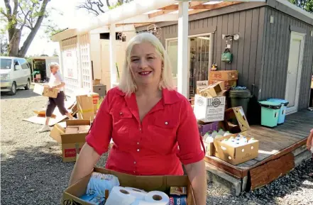  ??  ?? Larina "Lilly" Tiffen sorting supplies for Kaikoura dropped off at her house.