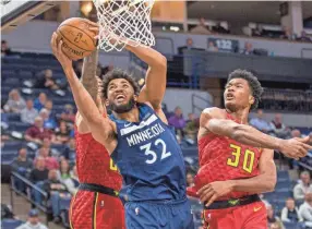  ?? JESSE JOHNSON/USA TODAY SPORTS ?? Timberwolv­es center Karl-anthony Towns goes to the basket against the Hawks on Feb. 5 in Atlanta.