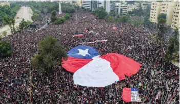  ?? — AFP ?? An aerial view of people demonstrat­ing with a giant Chilean national flag against the government of Chilean President Sebastian Pinera in Santiago.