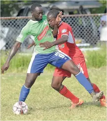  ?? IAN ALLEN ?? Dino Williams (left) of Montego Bay United tussles with Boys’ Town FC’s Ricardo Dennis during a Red Stripe Premier League match at the Barbican Complex on January 17.