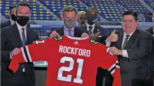  ?? BLACKHAWKS.COM ?? Blackhawks CEO Danny Wirtz, chairman Rocky Wirtz and Gov. J.B. Pritzker were on hand to announce the Blackhawks’ deal to buy the Rockford IceHogs.