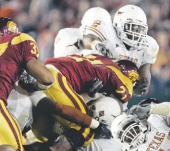  ?? Associated Press file ?? Texas players stop USC’S Lendale White from converting on a fourth-and-2 play in the fourth quarter of the national championsh­p game on Jan. 4, 2006.