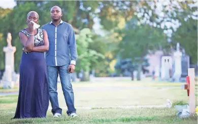  ?? MICHELLE KANAAR/THE TRACE ?? Chantal Mulumba with her brother, Antoine Mulumba, at the grave of her son, Darlis Nkolomi, at St. Boniface Catholic Cemetery. “I just came here for one thing, to have a better life, not to lose my son.”