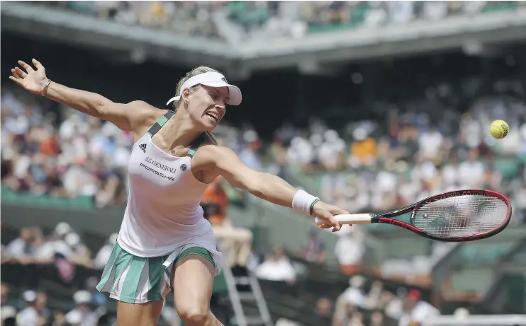  ?? — GETTY IMAGES ?? Top seed Angelique Kerber returns a shot to Ekaterina Makarova during their first-round match at the French Open in Paris. Kerber lost in straight sets.