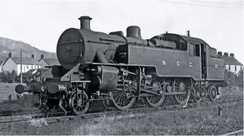  ?? A.W. CROUGHTON/RAIL ARCHIVE STEPHENSON ?? No. 52 at Greenislan­d, just north of Belfast, in 1950. You can see the shallow curve linking the tank to the cab. The first ‘Jeeps’ were delivered with tablet exchange apparatus on the cabside which only worked when going forwards. As the ‘Jeeps’ were designed to run just as well in reverse, this was problemati­c. In the end, tablet exchange gear was kept in the cab and plugged into special sockets depending on the direction of travel.