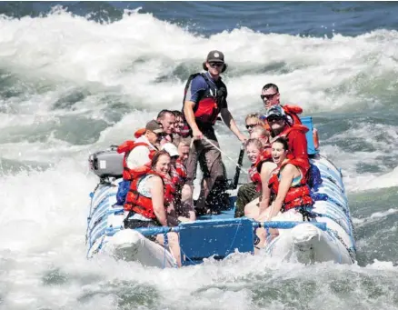  ?? Kumsheen Rafting Resort ?? Guide Steve Schadinger takes a J-boat load of passengers through some of the best whitewater rafting available in British Columbia.