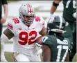  ?? AL GOLDIS — THE ASSOCIATED PRESS ?? Ohio State lineman Haskell Garrett, left, scores against Michigan State’s Tre Mosley after deflecting and catching a Michigan State pass in the end zone during the first half of a 2020game in East Lansing, Mich.