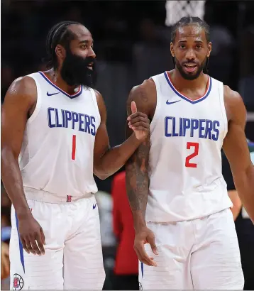  ?? KEVIN C. COX — GETTY IMAGES ?? James Harden (1) and Kawhi Leonard (2) chat during a timeout in the Clippers' 149-144victory over the Hawks on Monday night at Atlanta. Leonard scored 36points and Harden had 30in L.A.'s victory to end a 6-1road trip.