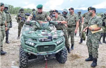  ??  ?? Zamrose tries out one of the army’s all-terrain vehicle.