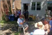  ?? NICHOLAS BUONANNO — NBUONANNO@TROYRECORD.COM ?? Local veteran Christine Rem is seen in the center speaking during the Native American blessing of the Veterans Victory Garden in South Troy.