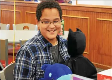  ?? MARIAN DENNIS — DIGITAL FIRST MEDIA ?? Talon Cleveland, 10, of Birdsboro is all smiles as he receives a box full of amusement park themed items given to himby Cayla Fleming Saturday at Friendly’s in Pottstown.