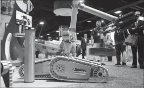  ?? BLOOMBERG VIA GETTY IMAGES ?? A robot designed by iRobot lifts a weight while on display at a recent unmanned vehicle exhibition held in the United States.