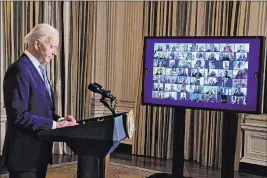  ?? Evan Vucci The Associated Press ?? President Joe Biden listens during a virtual swearing-in ceremony of political appointees from the State Dining Room of the White House on Wednesday.