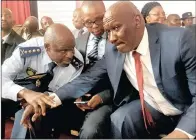  ?? PICTURE: SITHANDIWE VELAPHI ?? SHOOTING FROM THE LIP: National Police Commission­er General Khehla Sitole, left, new Police Minister Bheki Cele with his deputy Bongani Mkongi, centre, are seen together yesterday at the memorial service for the five officers killed in the Ngcobo police station shooting last week.