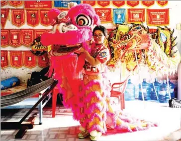  ?? AFP ?? Le Yen Quyen poses with her lion dance mask before a practice session at the Tu Anh Duong lion and dragon dance school in Can Tho city on January 20.