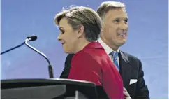  ?? JACQUES BOISSINOT / THE CANADIAN PRESS ?? Leadership candidates Kellie Leitch and Maxime Bernier greet each other at the beginning of the Tuesday’s debate.