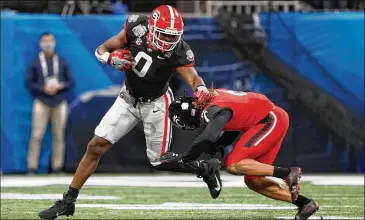  ?? JASON PARKHURST VIA ABELL IMAGES AP ?? UGA tight end Darnell Washington, trying to avoid a tackle during the Chick-fil-a Peach Bowl on Jan. 1, had seven receptions for 166 yards and no touchdowns as a freshman last season.