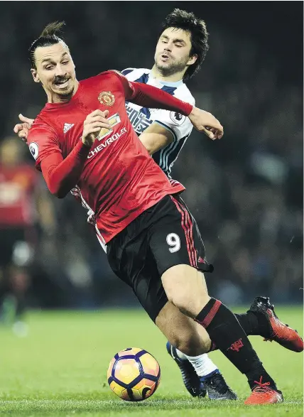  ?? — GETTY IMAGES ?? Manchester United’s Zlatan Ibrahimovi­c scored a pair of goals against Claudio Yacob and West Bromwich Albion in Saturday’s 2-0 English Premier League match win at The Hawthorns stadium in West Bromwich, England. United is still 13 points behind...