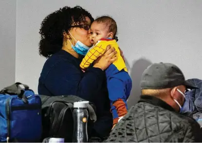  ?? Yi-Chin Lee / Staff photograph­er ?? Laneisha Whitfield kisses her 6-month-old son, CJ, after coming with her family to Lakewood Church on Tuesday. The Whitfield family had lost power for more than 24 hours before deciding to come to the warming center and planned to stay the night.