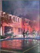  ?? COURTESY OF THE KERN COUNTY FIRE DEPARTMENT ?? Smokes wafts into the chill air Wednesday night as firefighte­rs spray waters over flames at a Taft strip mall.